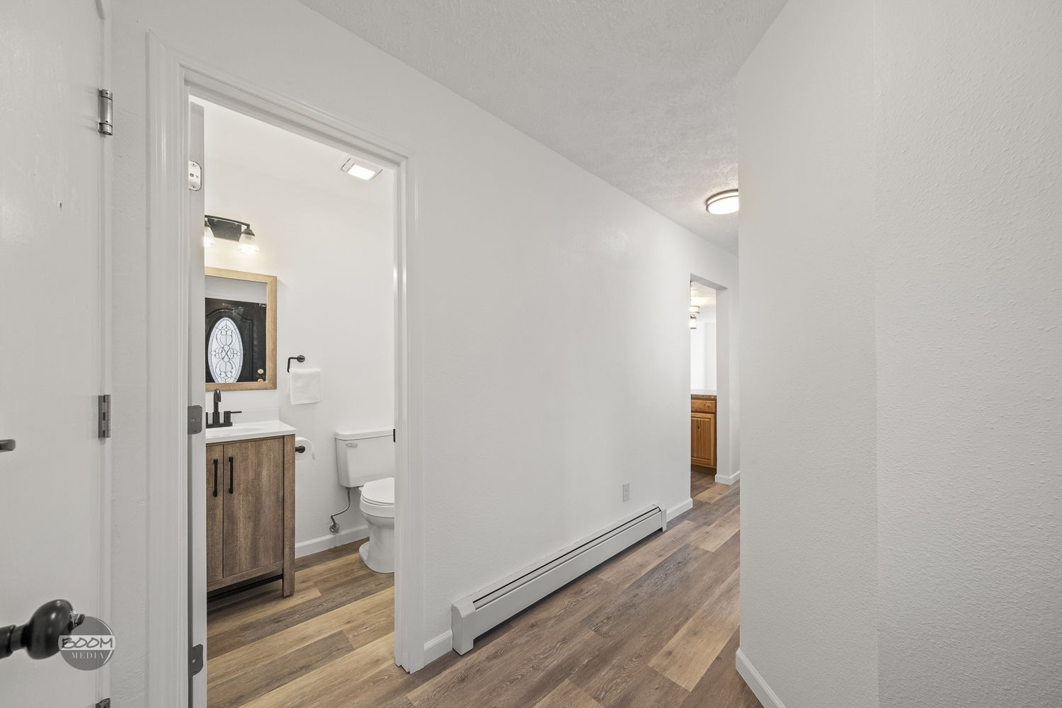 Hallway leading to a finished bathroom
