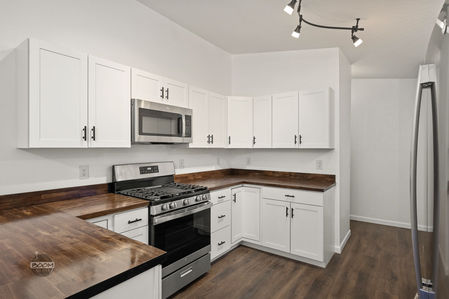Kitchen with a gas range, stainless appliances and butcher-block counters
