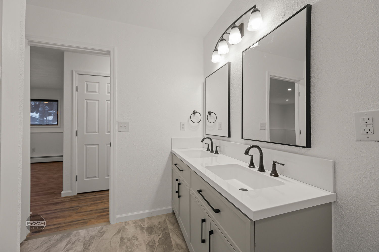 Double vanity with framed mirrors and new lighting