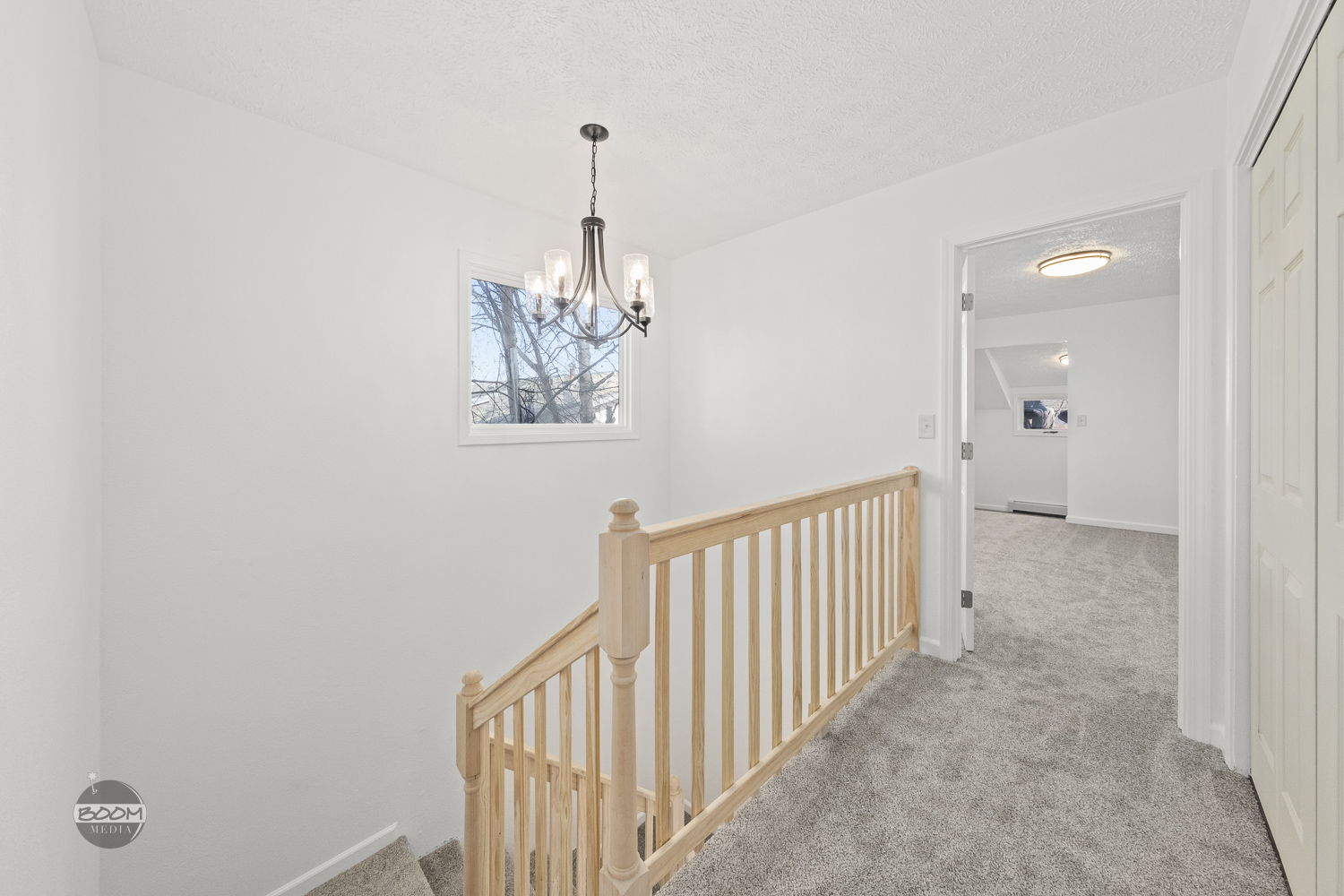 Upper landing with a rebuilt stair railing and new carpet