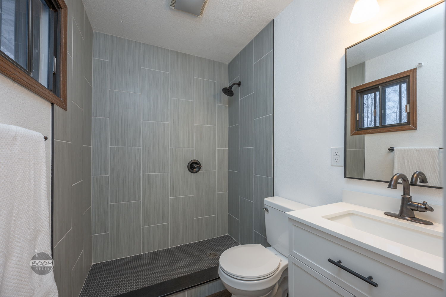 Tiled curbless walk-in shower in a remodeled bathroom